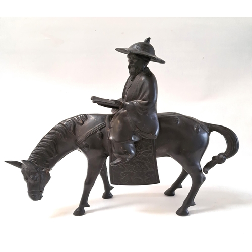 266 - JAPANESE METAL EQUESTRIAN FIGURE
of a sage riding a horse while reading a scroll, the horses tail be... 