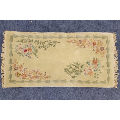 461 - CHINESE WASH RUG 
with pale green ground and floral motifs, 147cm x 76cm