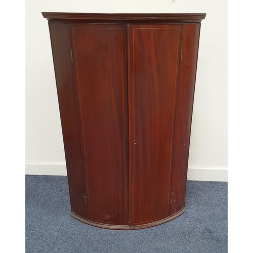 500 - GEORGE III MAHOGANY BOW FRONT CORNER CUPBOARD
with a pair of doors opening to reveal shaped shelves,... 