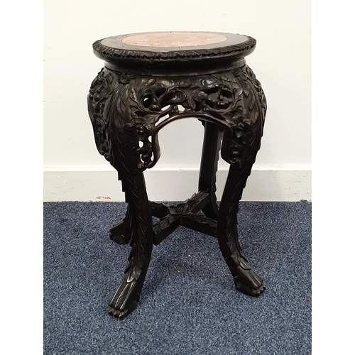 523 - CHINESE HARDWOOD JARDINERE STAND
with a circular inset red veined marble top above a carved frieze, ... 