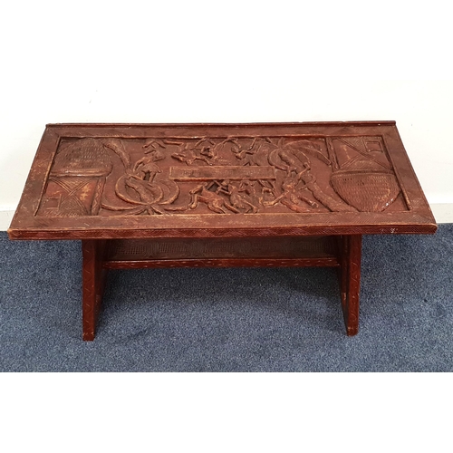 555 - VINTAGE WEST AFRICAN CARVED AND STAINED WOOD OCCASIONAL TABLE
the top carved with figures animals, t... 