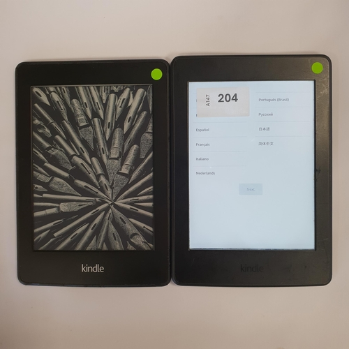 204 - TWO AMAZON KINDLE PAPERWHITE E-READERS 
comprising a Paperwhite 2, serial numbers 90D4 2201 4024 0XE... 