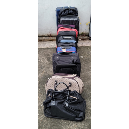 5 - EIGHT SUITCASES AND FOUR HOLDALLS (12)
Including Slazenger, Envoy, Revelation and Tripp
Note: All su... 