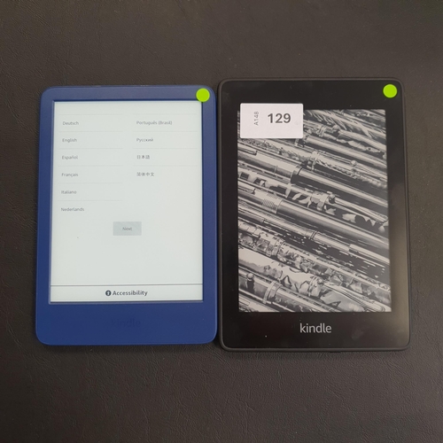 129 - TWO AMAZON KINDLE E-READERS
comprising a Paperwhite 4 10th generation, serial number G8SO T613 1057 ... 