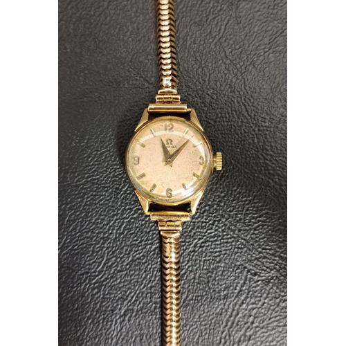 89 - LADIES NINE CARAT GOLD CASED OMEGA WATCH
the circular dial with Arabic numerals and 3, 6, 9 and 12, ... 