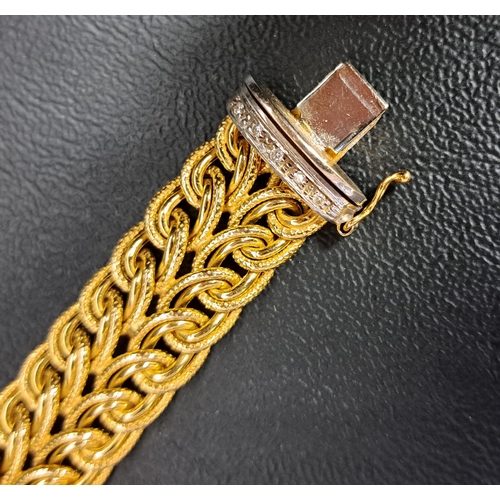 27 - UNUSUAL DIAMOND SET NINE CARAT GOLD BRACELET
the interwoven yellow gold bracelet with diamond set wh... 