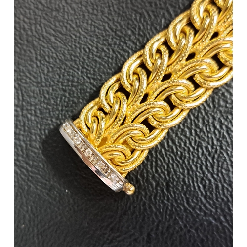 27 - UNUSUAL DIAMOND SET NINE CARAT GOLD BRACELET
the interwoven yellow gold bracelet with diamond set wh... 