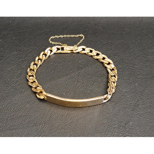 39 - NINE CARAT GOLD IDENTITY BRACELET
the blank panel flanked by textured curb links, with safety chain,... 