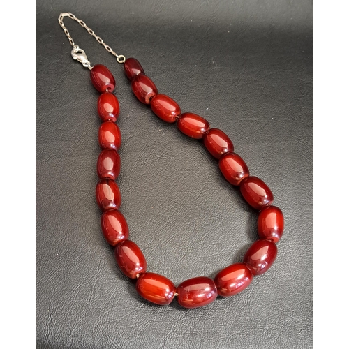 61 - CHERRY AMBER BEAD NECKLACE
the beads strung on silver chain, all the beads approximately 2cm long, t... 