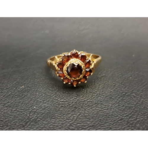 63 - GARNET CLUSTER RING
the central round cut garnet approximately 0.75cts in further ten garnet surroun... 