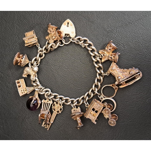 110 - SILVER CHARM BRACLET
with a good selection of charms including articulated examples - ice skate, typ... 