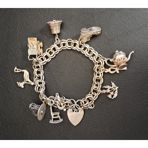 117 - FANCY LINK SILVER CHARM BRACELET
the charms including an articulated teapot and shoe, a bell and a s... 