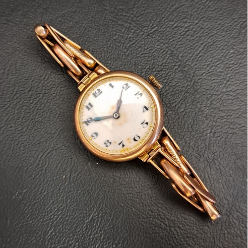 130 - LADIES NINE CARAT GOLD CASED WRISTWATCH
circa 1920s, the white enamel dial with Arabic numerals, on ... 