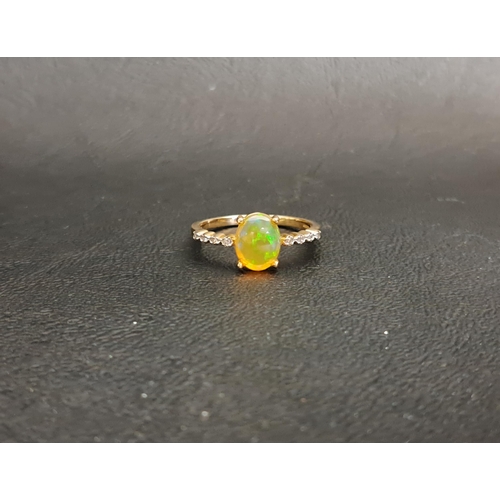 19 - ETHIOPIAN OPAL AND DIAMOND RING
the central oval cabochon opal measuring 8.7mm x 6.8mm, flanked by d... 