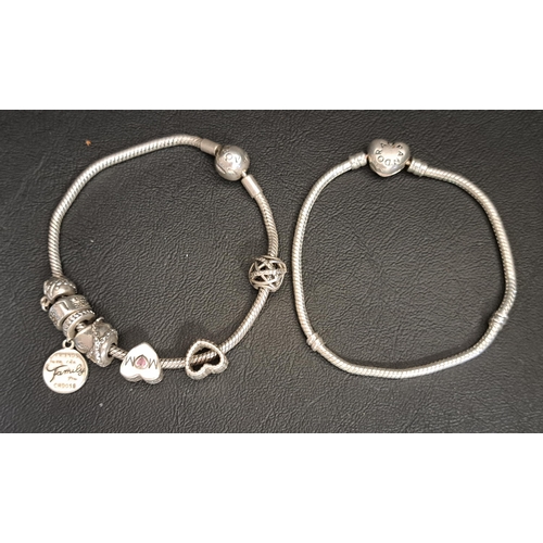 66 - TWO PANDORA SILVER MOMENTS CHARM BRACELETS
one with heart clasp, the other with six charms