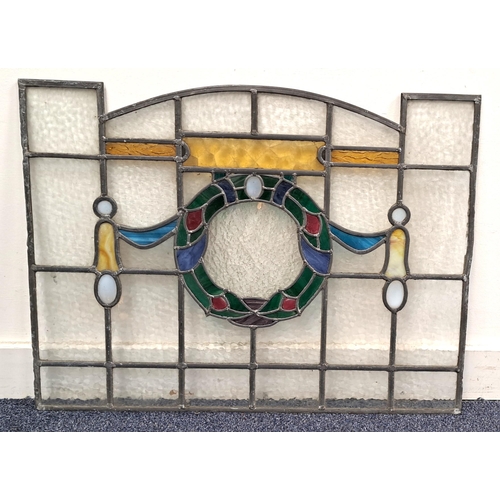 463 - ARTS AND CRAFTS STAINED GLASS LEADED PANEL
depicting a wreath with ribbons and opaque glass cartouch... 