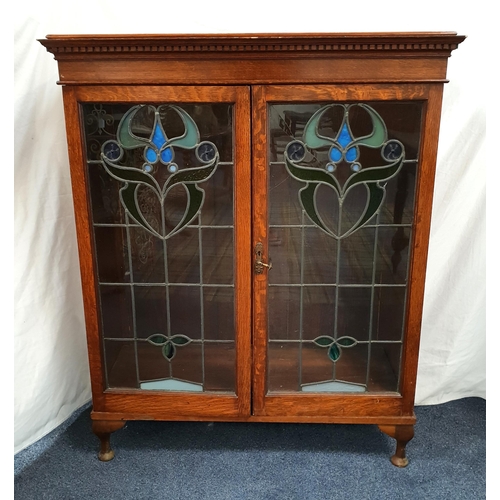 434 - EDWARDIAN OAK ARTS AND CRAFTS GLAZED FRONTED BOOKCASE/DISPLAY CASE
with leaded glass depicting flowe... 