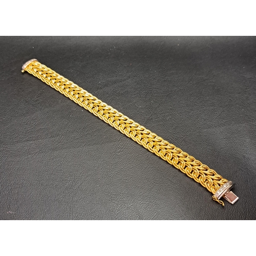 27 - UNUSUAL DIAMOND SET NINE CARAT GOLD BRACELET
the interwoven yellow gold bracelet with diamond set wh... 