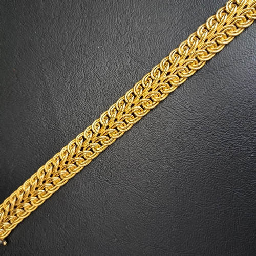 27 - UNUSUAL DIAMOND SET NINE CARAT GOLD BRACELET
the interwoven yellow gold bracelet with diamond set wh... 