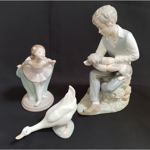 229 - THREE NAO FIGURES
including Ballerina, 18cm high; Boy with dog, 26cm high; and a Goose, 11cm high (3... 