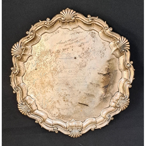 EDWARDIAN SILVER PRESENTATION SALVER
with scroll and shell decorated rim and raised on three claw feet, the centre with inscription 'Presented to C. H. Cullen from the President and Council in recognition of his valued services to the United Kingdom Bartenders Club', surrounded by engraved signatures, Sheffield hallmarks for 1909, Martin Hall & Co., 27cm x 26cm, 588g/20.7oz