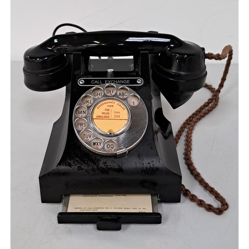 VINTAGE #300 SERIES GPO BLACK BAKELITE CALL EXCHANGE TELEPHONE
with chrome dial and buttons, numbers in red and letters in black, serial number 164 57 under hand set, rubber feet and number 312L PL57/3A to base, with pull out drawer with numbers, call exchange button, and braided handset chord