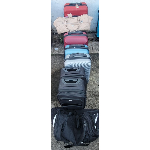 4 - SELECTION OF EIGHT SUITCASES AND TWO HOLDALLS
including: Baggin Polo, Slazenger, Guess, Puma
Note: S... 