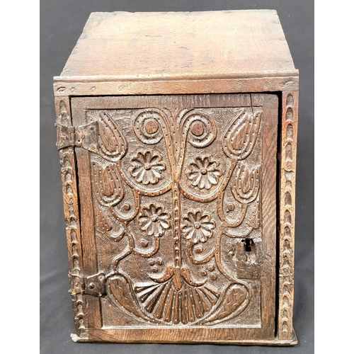 321 - AN EARLY OAK LOCK BOX
with tulip and floral carving to door with further dot detail and with iron br... 