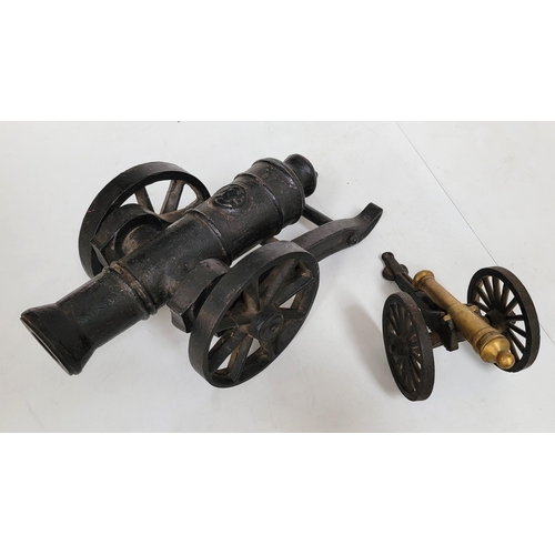 334 - BLACK WROUGHT IRON MODEL OF A CANNON AND CARRIAGE
34cms long, with a further small table cannon of b... 