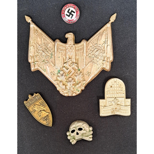 497 - SELECTION OF WWII STYLE NAZI BADGES
including an eagle plaque, a Panzer collar skull, an enamelled e... 