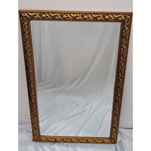 555 - LARGE GILT FRAMED BEVEL EDGED MORRIS WALL MIRROR
with vine and grape design frame, 121 x 73cm