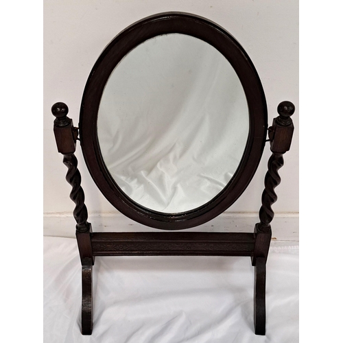 561 - OAK DRESSING TABLE MIRROR
the oval swing mirror on barley twist supports and motif carved stand, 44c... 