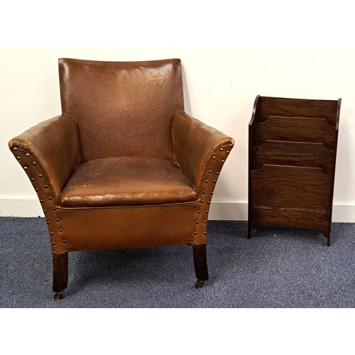 563 - VINTAGE LEATHER EFFECT ARMCHAIR
with studded detail and raised on casters; together with an oak maga... 