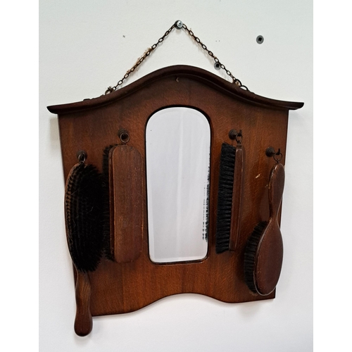 593 - VINTAGE MAHOGANY HALLWAY VANITY BRUSH SET 
with four various brushes on hooks and a mirror, 39 x 40 ... 