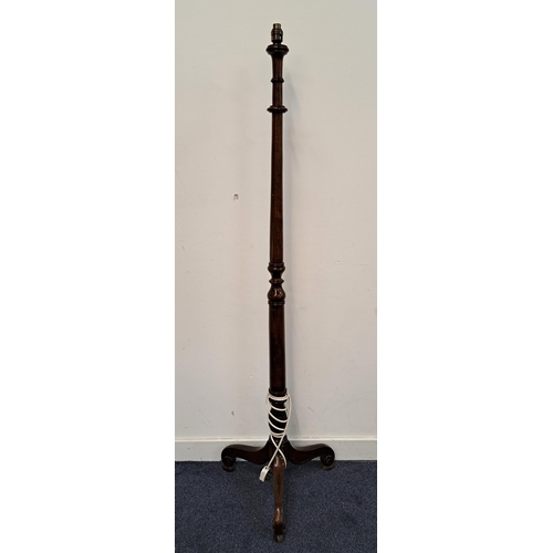 560 - MAHOGANY STANDARD LAMP 
the turned column raised on three legs with scroll feet below acanthus leaf ... 