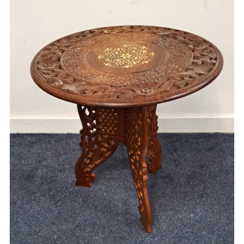 581 - PIERCED AND CARVED TEAK SIDE TABLE
the top with floral inlaid resin detail, on pierced folding stand