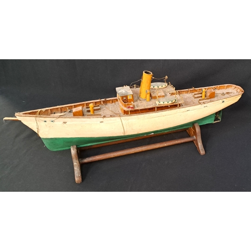 359 - MOTORISED MODEL BOAT
with green and cream hull, on stand, 69 x 26 x 14cm