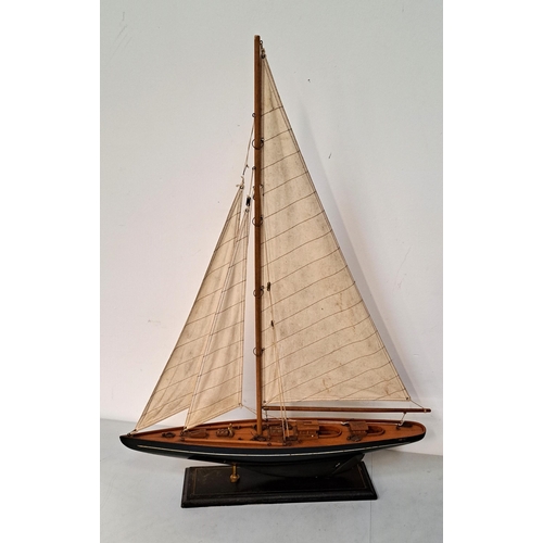 360 - MODEL YACHT
with blue navy hull and sails and rigging on stand, 62 x 82 x 11cm