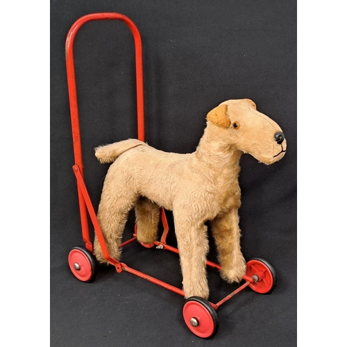 446 - VINTAGE PEDIGREE SOFT TOYS PUSH ALONG DOG
the mohair covered dog on red painted steel frame with whe... 