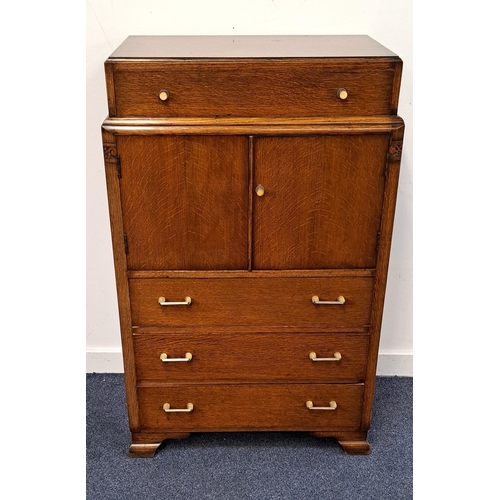 615 - ART DECO OAK SIDE CABINET
the top drawer above two cupboard doors and with three further drawers bel... 