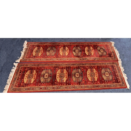 620 - PAIR OF WOOLEN KIRMAN STYLE RUNNERS
by Atlantik, on red ground, 80 x 300cm each