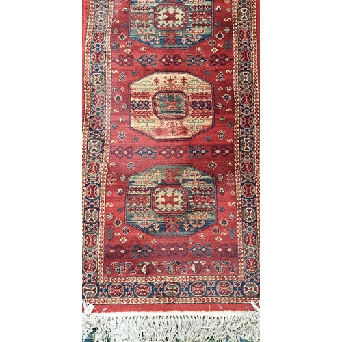 620 - PAIR OF WOOLEN KIRMAN STYLE RUNNERS
by Atlantik, on red ground, 80 x 300cm each