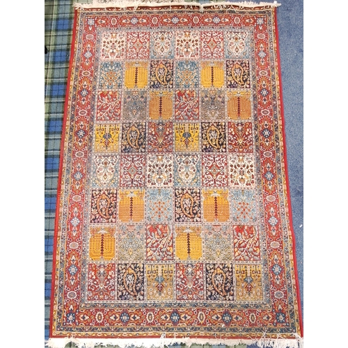 624 - BAKHTIAR STYLE CARPET
with red ground border surrounding chequerboard field with flora and fauna mot... 