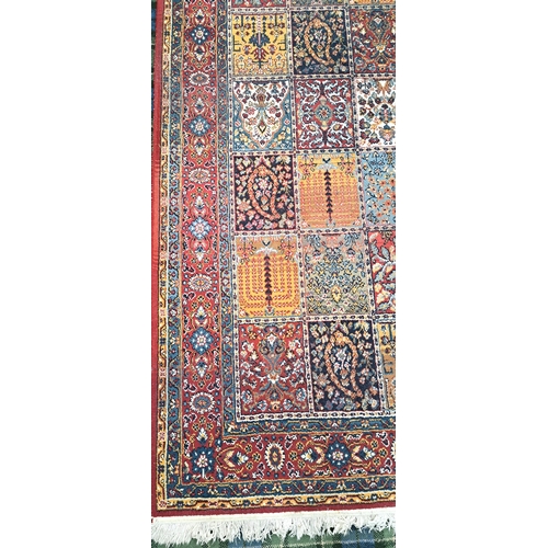 624 - BAKHTIAR STYLE CARPET
with red ground border surrounding chequerboard field with flora and fauna mot... 