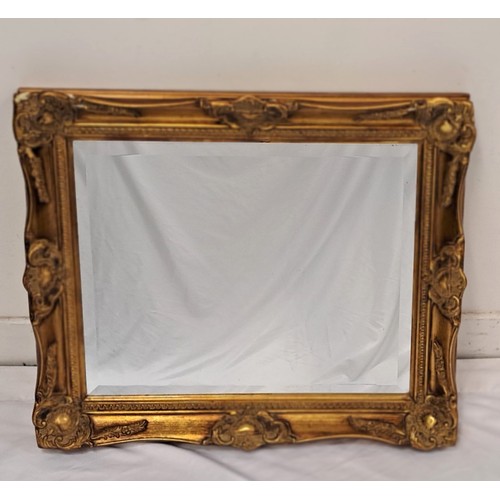 635 - GILT FRAMED WALL MIRROR
the bevel edged rectangular mirror in framed with foliate, scroll and shell ... 