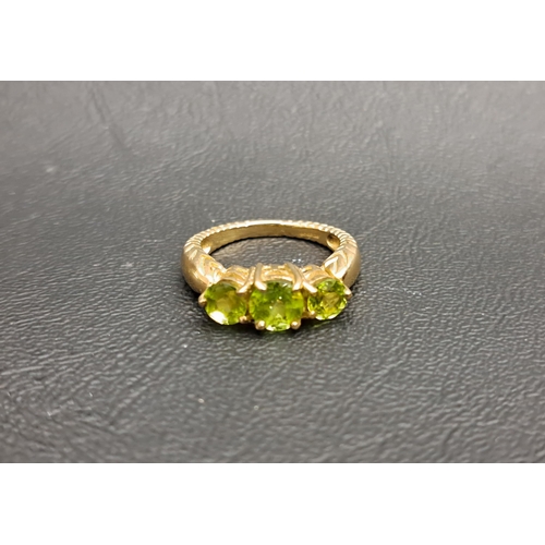 77 - GRADUATED PERIDOT THREE STONE RING
the round cut gemstones on nine carat gold shank, ring size N and... 