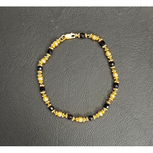 89 - TWENTY TWO CARAT GOLD BRACELET
the gold sections interspersed with small faceted glass beads, approx... 