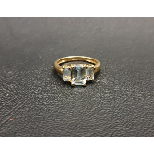 96 - GRADUATED AQUAMARINE THREE STONE RING
the rectangular step cut gemstones, totalling approximately 0.... 