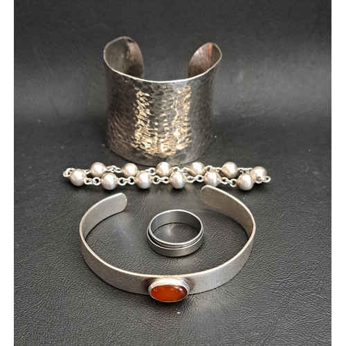 7 - LARGE HAMMERED SILVER CUFF BANGLE
together with a cabochon carnelian set silver bangle; and a silver... 