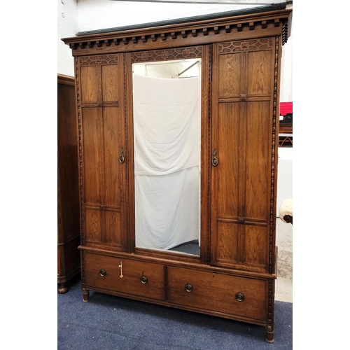 614 - LARGE OAK WADROBE
the moulded cornice above central mirror door and smaller flanking doors, all with... 